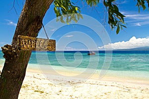 Welcome sign to paradise beach and sea on island