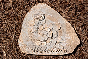 Welcome Stepping Stone on Pine Straw