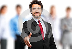 Welcome into the team: businessman giving his hand