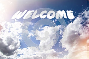 Welcome. Text from clouds in sky in bright sunlight.