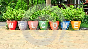 Welcome text sign on colorful pottery