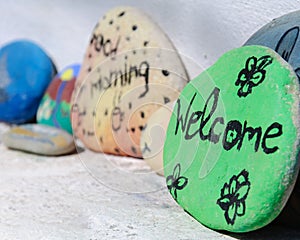 Welcome Text Written on the painted Stone