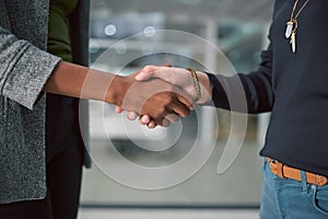 Welcome to the company. two creative businesspeople shaking hands.