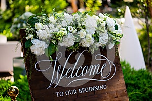 WELCOME TO OUR BEGINNING. Garden party. Wedding decor table setting and flowers. Wedding Flower Arrangement Table Setting Series