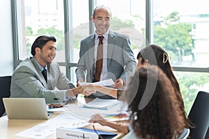 Welcome to our team. Young business modern women in smart casual wear shaking hands while working in the office