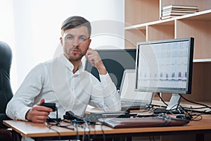 Welcome to our workplace. Polygraph examiner works in the office with his lie detector`s equipment