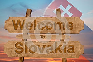 Welcome to Slovakia sign on wood background with blending national flag