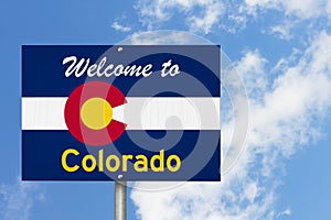 Welcome to the state of Colorado road sign in the shape of the state map with the flag