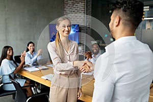 Welcome To Team. Boss Shaking Hands With New Female Employee In Office