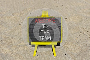 Welcome to the team symbol. Concept words Welcome to the team on beautiful black chalk blackboard. Beautiful sand beach background