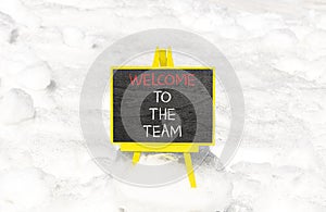 Welcome to the team symbol. Concept words Welcome to the team on beautiful black chalk blackboard. Beautiful white snow background