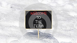 Welcome to the team symbol. Concept words Welcome to the team on beautiful black chalk blackboard. Beautiful white snow background