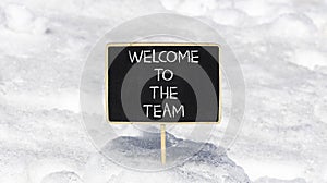Welcome to the team symbol. Concept words Welcome to the team on beautiful black chalk blackboard. Beautiful white snow background
