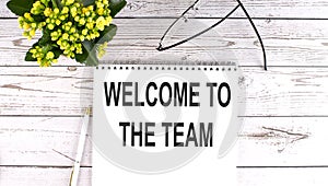 WELCOME TO TEAM text concept write on notebook on wooden background