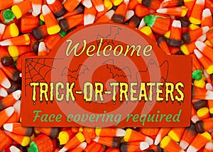Welcome Trick or Treaters greeting sign face covering required
