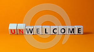 Welcome or unwelcome symbol. Turned wooden cubes and changed the word unwelcome to welcome. Beautiful orange table, orange