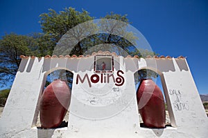 Welcome white wall and sign in Molinos, near Cachi. Argentina