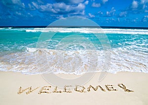 welcome written in beach