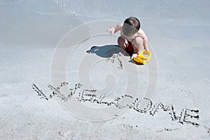 Welcome written in a sandy beach