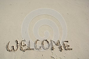 Welcome written in a tropical beach.