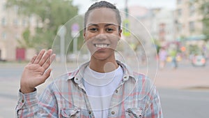 Welcoming African Woman Waving Hand for Hello Outdoor