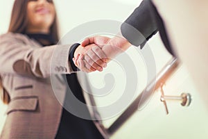 Welcoming business woman giving a handshake