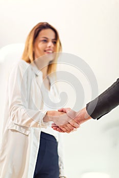 Welcoming business woman giving a handshake