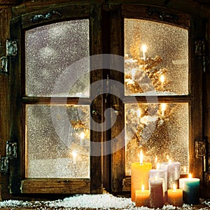 Welcoming Christmas window in a log cabin photo