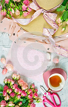 Welcoming Spring theme concept tea break with pink roses and female accessories.