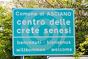 Welcoming street sign near Asciano SI, Tuscany, Italy