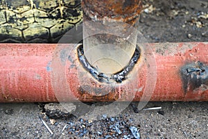 Welded tee joint with some defects. Two metal pipes welded together in T-joint