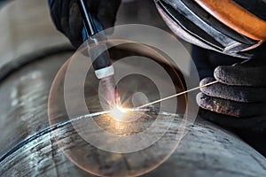 Welder, arc welding and weld seam close-up