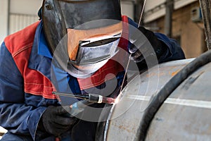 Welder, arc welding and weld seam close-up