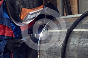 Welder, arc welding and weld seam close-up