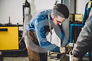 Welder checking angle of welded materials