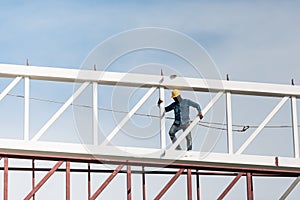 Welder climbing high on the steel structure