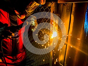 Workers are welding structural steel.