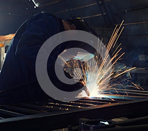 Welder, craftsman, erecting technical steel Industrial steel welder in factory