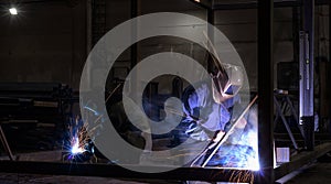 Welder, craftsman, erecting technical steel Industrial steel welder in factory