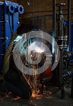 Welder, craftsman, erecting technical steel Industrial steel welder in factory