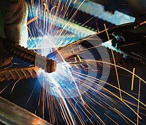 Welder, craftsman, erecting technical steel Industrial steel welder in factory
