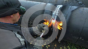 The welder cuts large metal pipes with ocetylene welding. 4K video. Close-up.