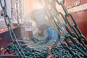 Welder doing welding on deck of ship lashing cargo
