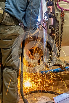 A welder grinding and welding