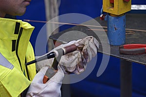 Welder hands preparing an argon torch for argon welding.