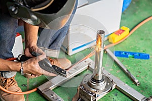 A welder makes a precision weld on a stainless-steel element