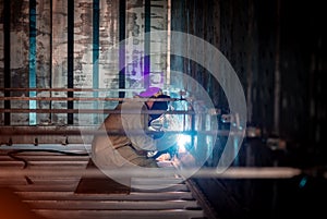 Welder makes welding inside an iron container