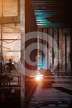 Welder makes welding inside an iron container