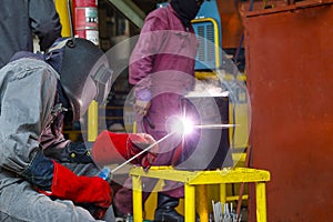 Welder man are welding reduce pipe