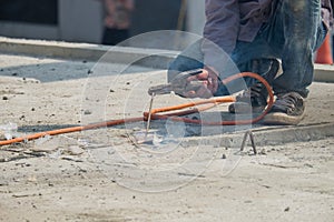 Welder man welding steel bars the supporting the precast concrete wall, worker with unprotected and unsafe.